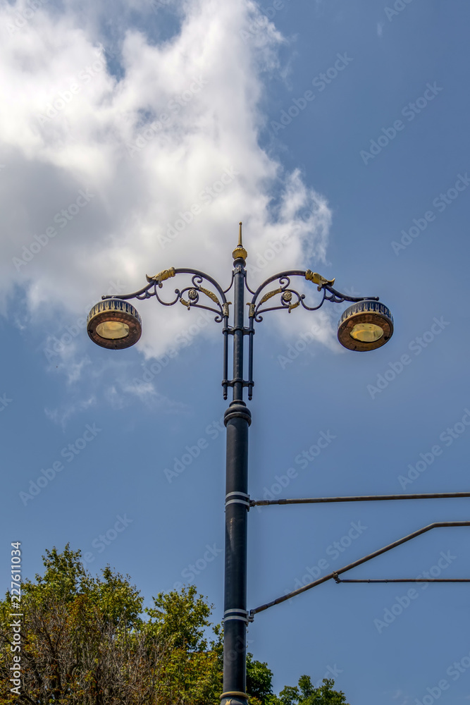 street lamps aligned with beautiful blue sky in background street lamps aligned with beautiful blue sky in background