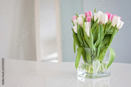 White and pink tulips on a white table were used as a Spring decoration background