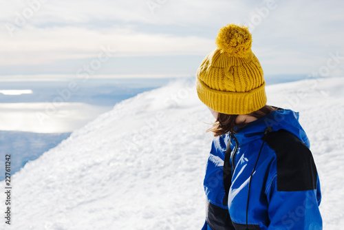 Portrait of a woman on the summit of a snow covered mountain photo
