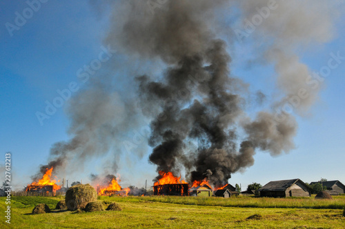 The fire in the village. Burning wooden huts and houses.