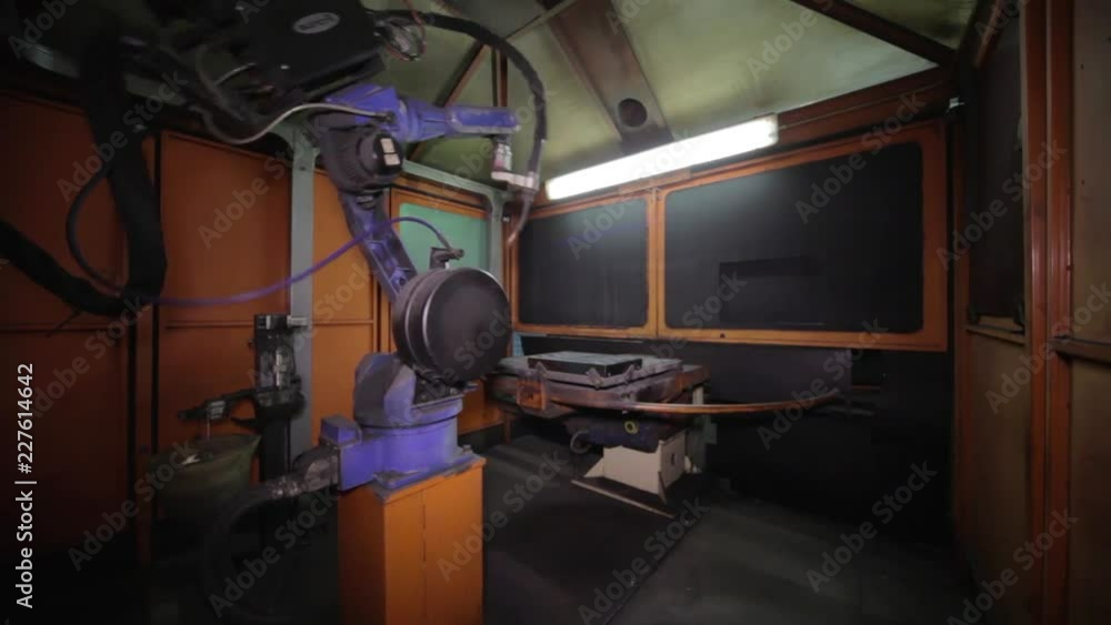 Welding Robot Arm during its work on an alluminium industrial piece. Welding Robot Arm during its work on an alluminium industrial piece.