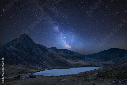 Digital composite Milky Way image of Stunning landscape image of countryside around Llyn Ogwen in Snowdonia