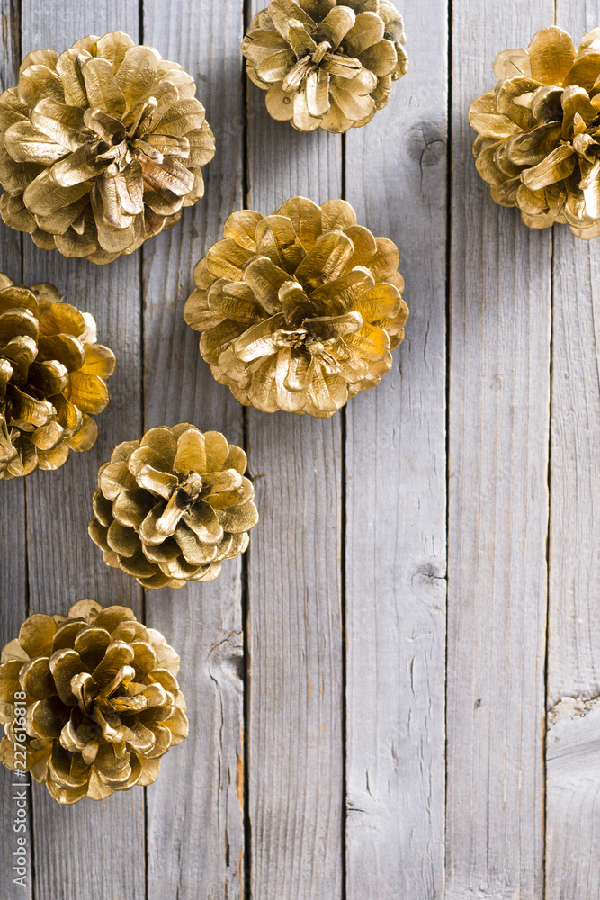 golden pine cones Christmas decoration on old rustic wooden table background golden pine cones Christmas decoration on old rustic wooden table background