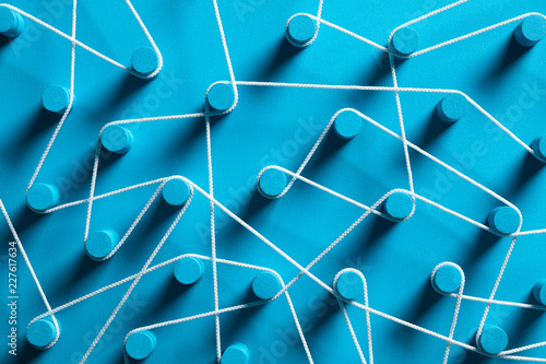Blue pins connected by white string.