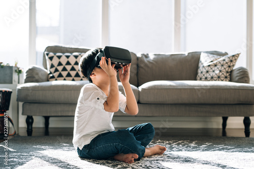 Boy wearing virtual glasses at home