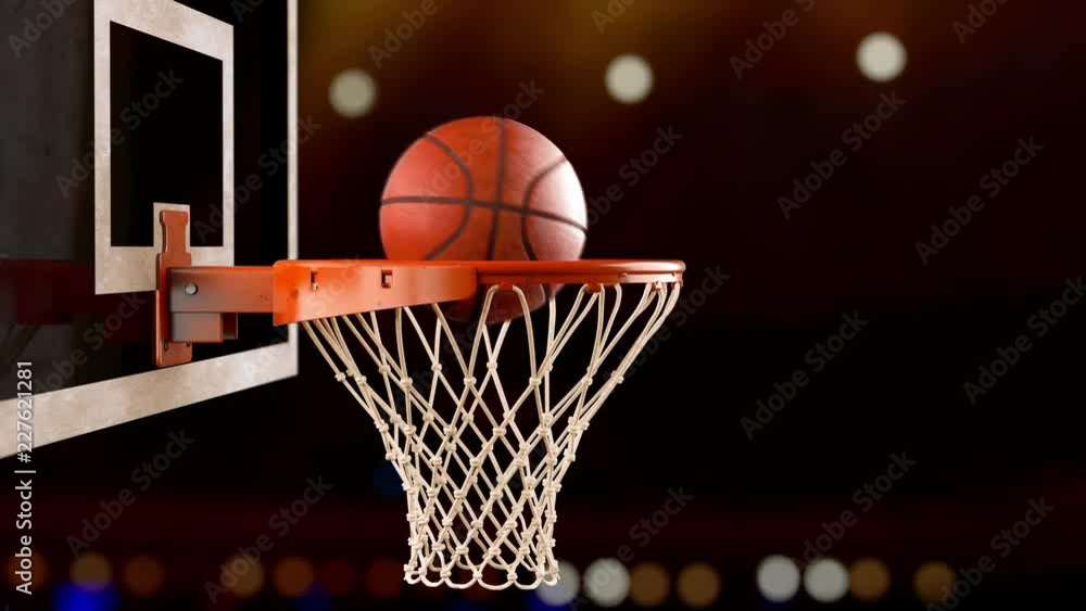 A throw basketball ball in a ring on the background of spotlights A throw basketball ball in a ring on the background of spotlights