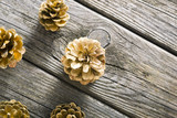 golden pine cones Christmas decoration on old wood table background