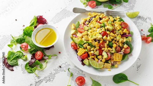 Sweet Corn salad with tomatoes, avocado, red onion, herbs and lime photo