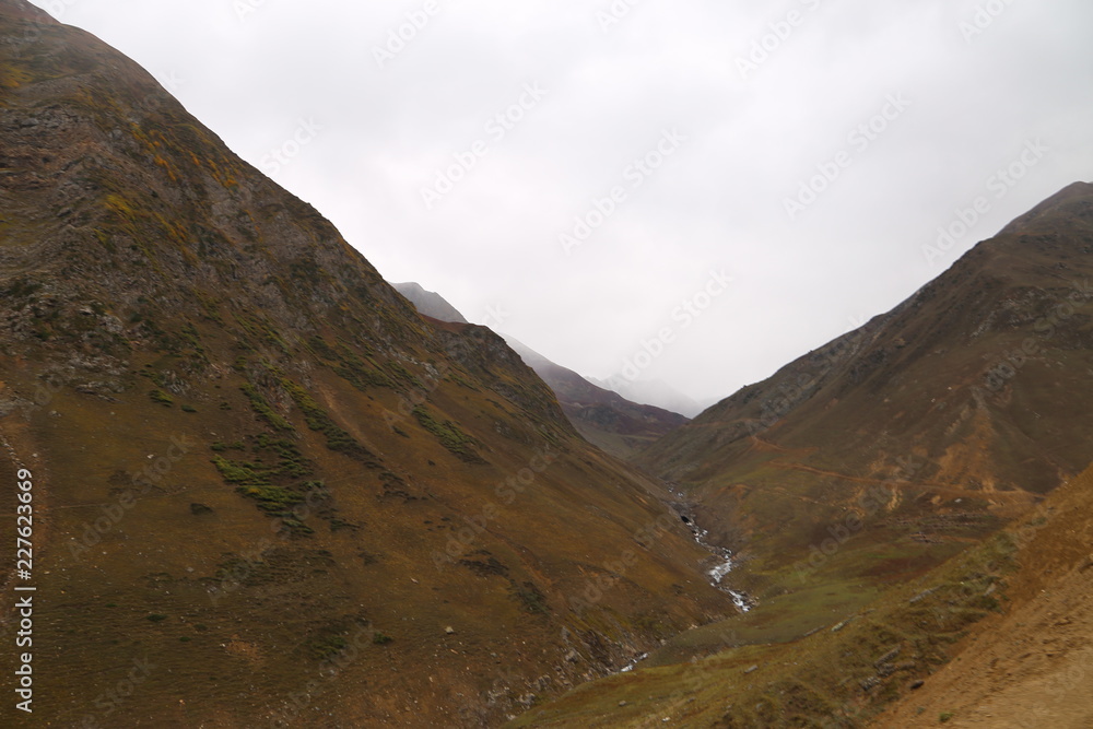 The mountain river flows between the rocks in the mountains The mountain river flows between the rocks in the mountains