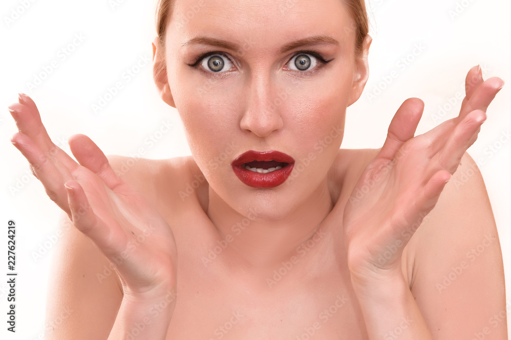 Beautiful blonde woman with pretty blue eyes and red lips. A scary female in pain holding her head and screaming in anger with an open mouth on her menstrual cycle period pain Beautiful blonde woman with pretty blue eyes and red lips. A scary female in pain holding her head and screaming in anger with an open mouth on her menstrual cycle period pain