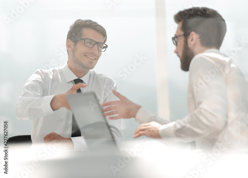 two employees greet each other at the Desk
