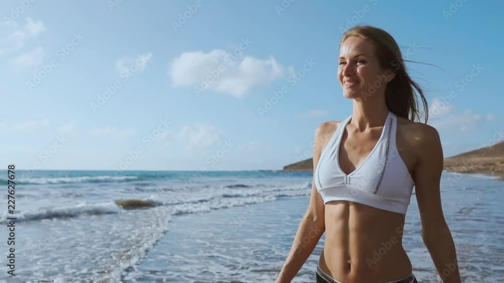 Young woman walking on beach Young woman walking on beach