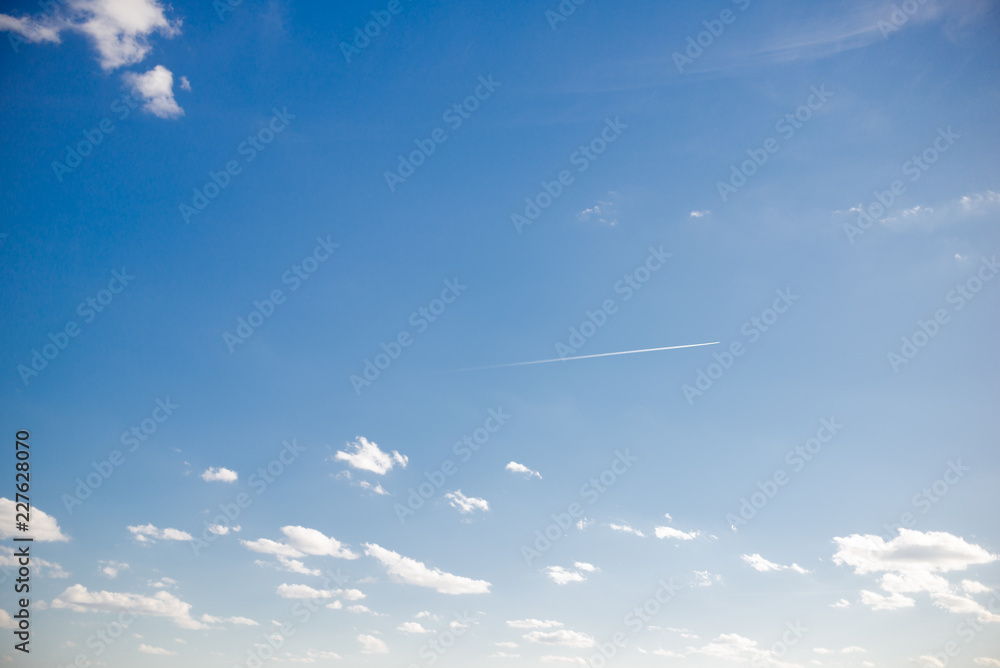 blue sky background with tiny clouds
