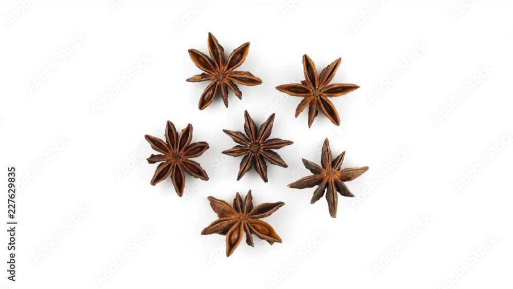 Top view from above of few dried badian fruits. Rotating on the turntable isolated on the white background. Close-up. Macro. Top view from above of few dried badian fruits. Rotating on the turntable isolated on the white background. Close-up. Macro.
