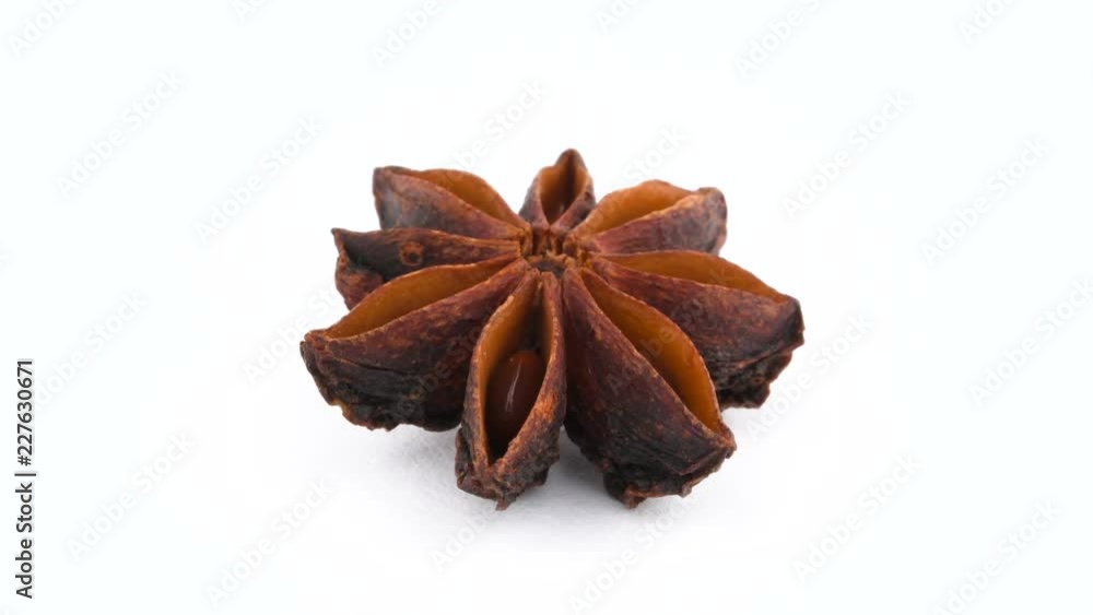 One dried star anise fruit. Rotating on the turntable isolated on the white background. Close up. Macro. One dried star anise fruit. Rotating on the turntable isolated on the white background. Close up. Macro.