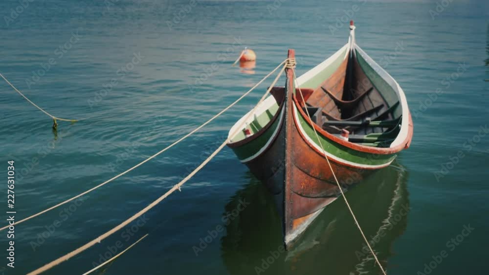 Beautiful wooden boat moored at the shore Beautiful wooden boat moored at the shore