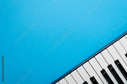 Abstract light-blue background with piano in the right corner 