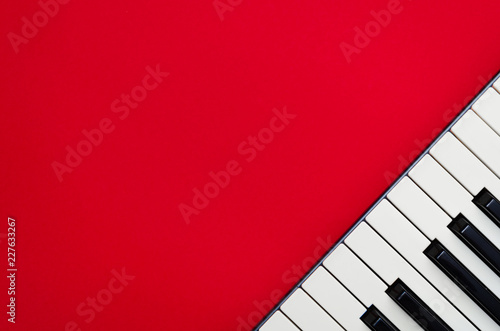 Piano keys in the corner of a red background