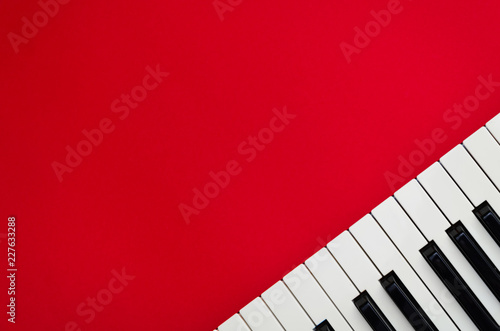 Piano keys in the right corner of a red background