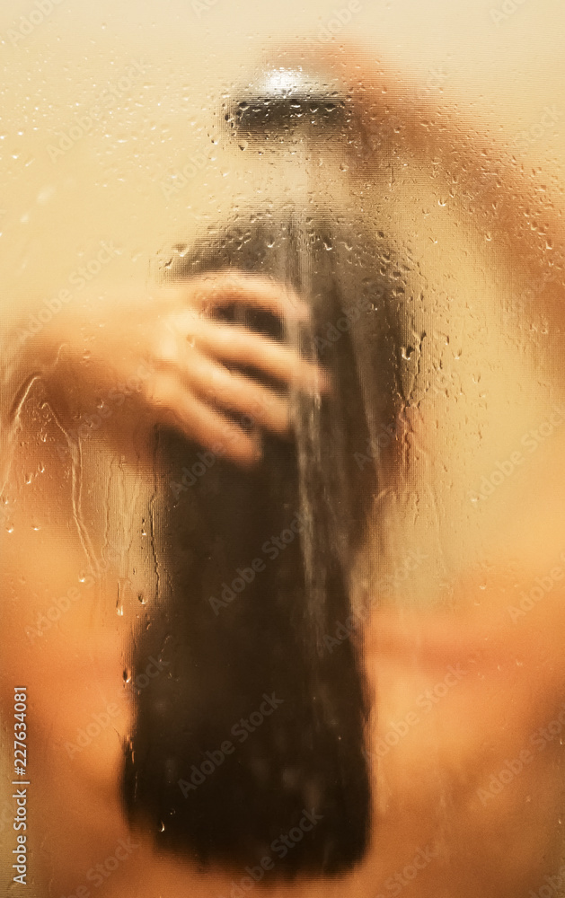 Woman washing her head in the shower.