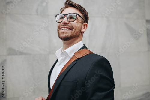 Close up of a smiling businessman looking away photo