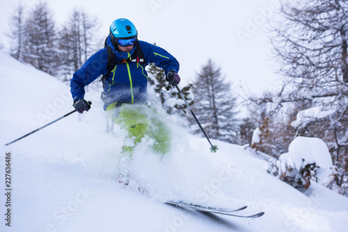 freeride skier skiing downhill