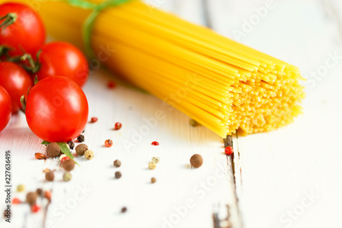 Cherry, spaghetti, spices Ingredients for cooking pasta. Food background on a white table