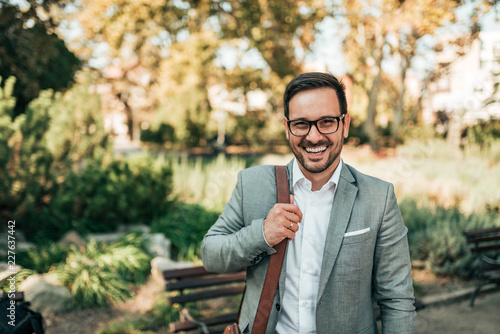 Portrait of a modern business man outdoors. Smiling and looking at camera.