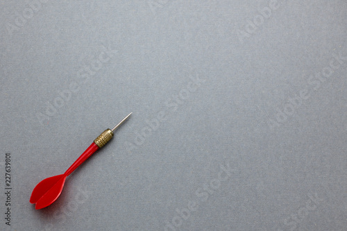 red darts on gray paper background