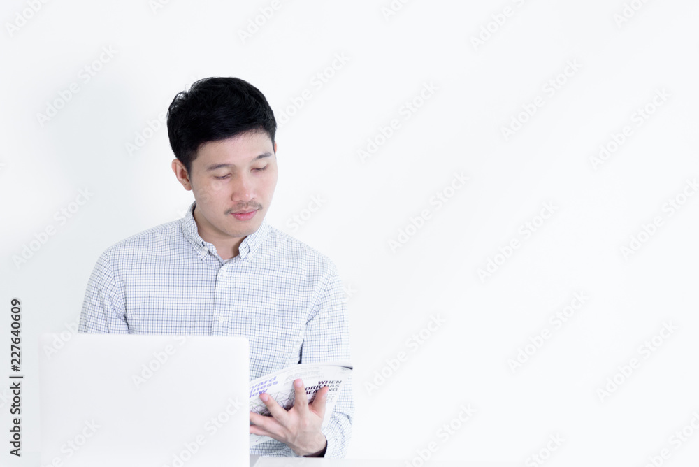 Asian employee man sitting at desk and working with copy space, isolated on white background. Asian employee man sitting at desk and working with copy space, isolated on white background.