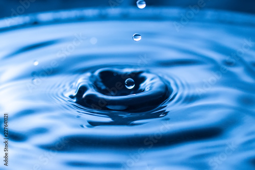 water drop splash in a glass blue colored