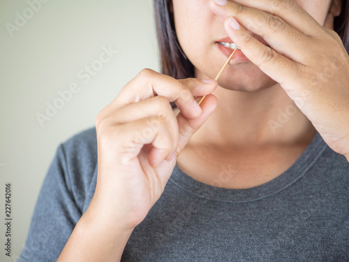 women using toothpick.