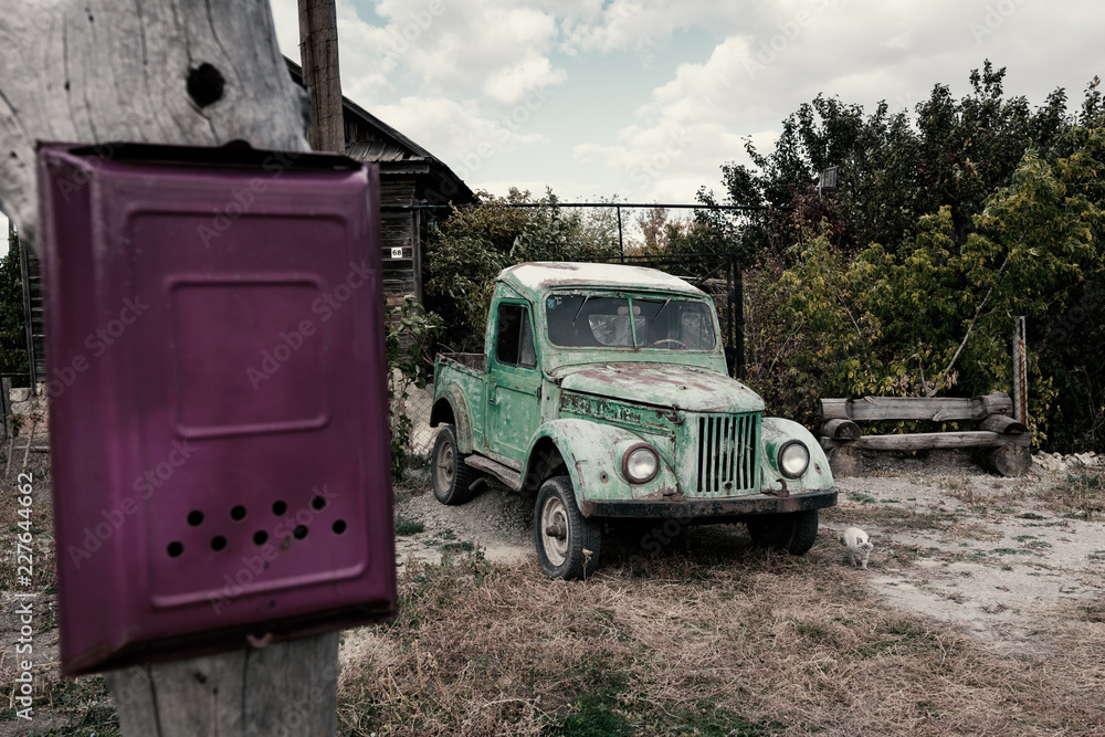 Old car near the house and mailbox on the post Old car near the house and mailbox on the post