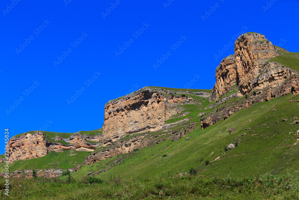Stone ledge of a rocky ridge against the blue sky. Stone ledge of a rocky ridge against the blue sky.