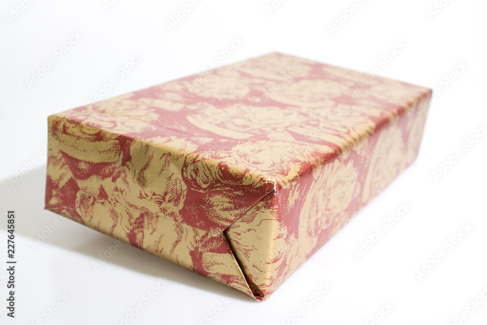 Christmas gift with red and gold paper isolated in a white background Christmas gift with red and gold paper isolated in a white background