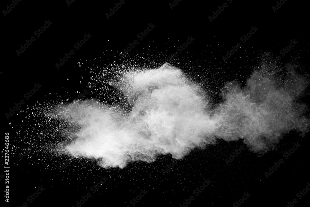 Fototapeta premium Explosion of white dust on black background.