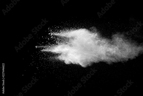 Explosion of white dust on black background.