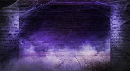 The background of the old brick wall, cracks in the wall, cobweb, neon light. Old basement room with cobwebs, smoke, smog. Dark gloomy background for the holiday of Halloween.
