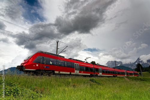 Red train in the area of Bavarian Alps in Germany