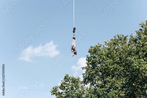 Person jumped with a rope for pleasure and adrenaline. Bungee Jumping. Active sport.