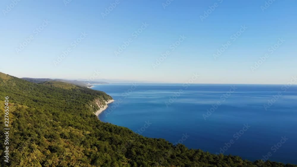 Aerial of flying over a beautiful green forest and sea in a rural landscape. Russia, Krasnodar region. Aerial of flying over a beautiful green forest and sea in a rural landscape. Russia, Krasnodar region.