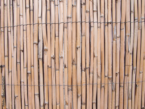 full frame cracked faded old bamboo fence background