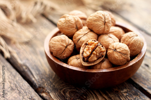 Walnuts in a bowl on wooden table