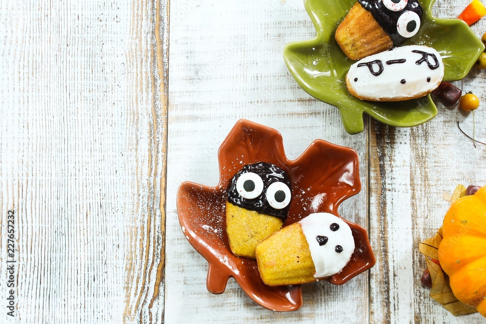 Homemade Halloween treats ghost Tombstone spooky Madeleines,Top view Homemade Halloween treats ghost Tombstone spooky Madeleines,Top view