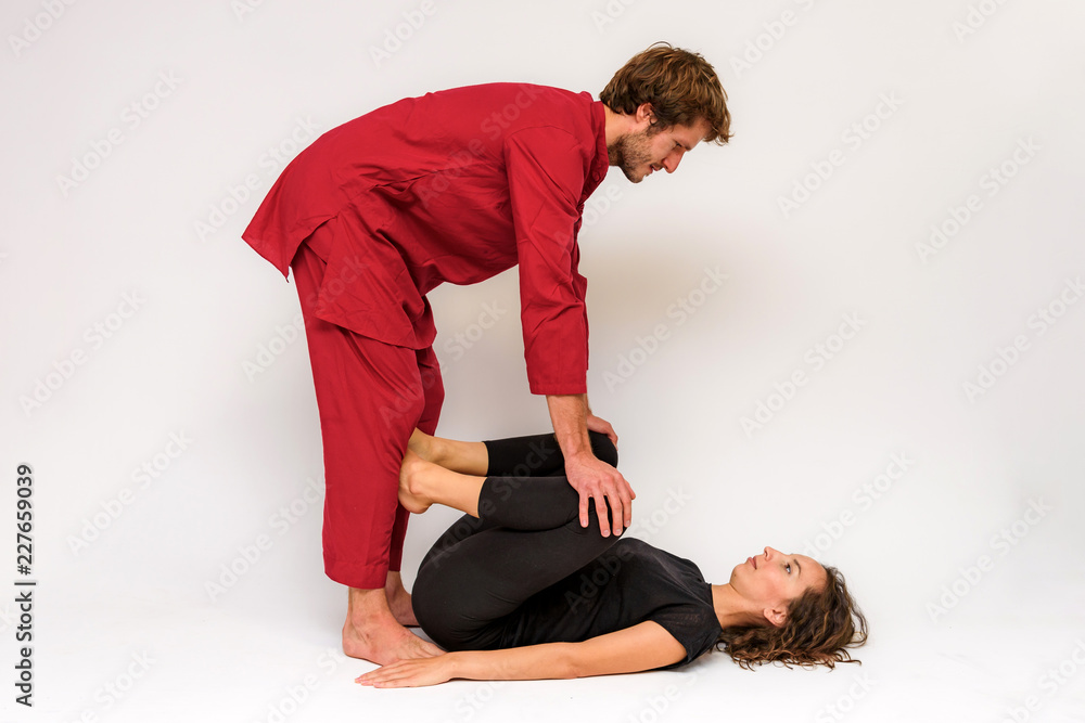 Photo of yoga poses for two stretching and relaxing on a white background. Photo of yoga poses for two stretching and relaxing on a white background.