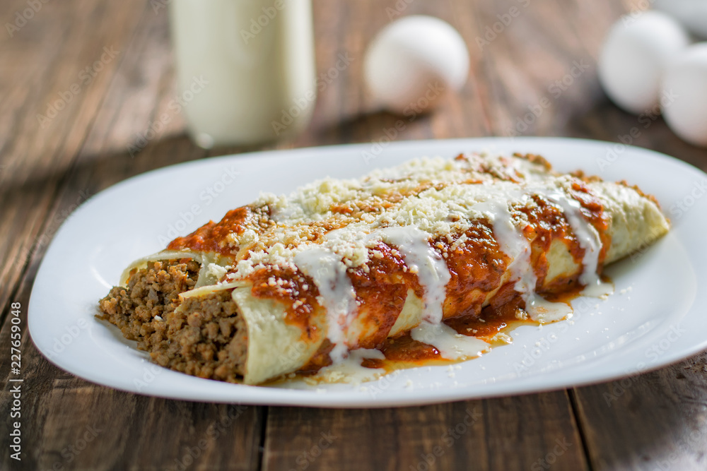Delicious sliced pancakes with meat and tomato sauce Delicious sliced pancakes with meat and tomato sauce