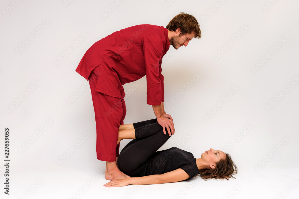 Photo of yoga poses for two stretching and relaxing on a white background. Photo of yoga poses for two stretching and relaxing on a white background.