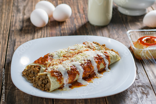 Delicious sliced pancakes with meat and tomato sauce