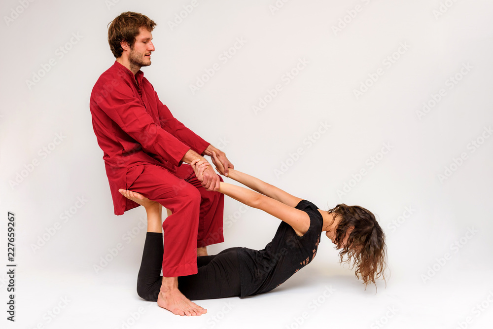 Photo of yoga poses for two stretching and relaxing on a white background. Photo of yoga poses for two stretching and relaxing on a white background.