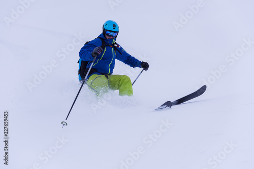 freeride skier skiing downhill